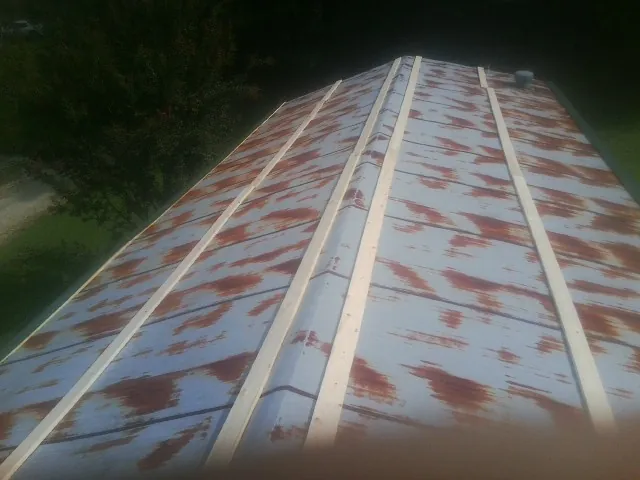 Rusted metal roof panels with new wood purlins before replacement — Storm Damage Roof Repair in Cuthbert by Roofing Brothers